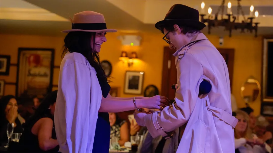 A Murder Mystery Company detective questioning a guest at a Minneapolis show